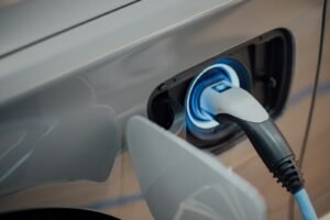 An electric vehicle charging connector plugged into a car